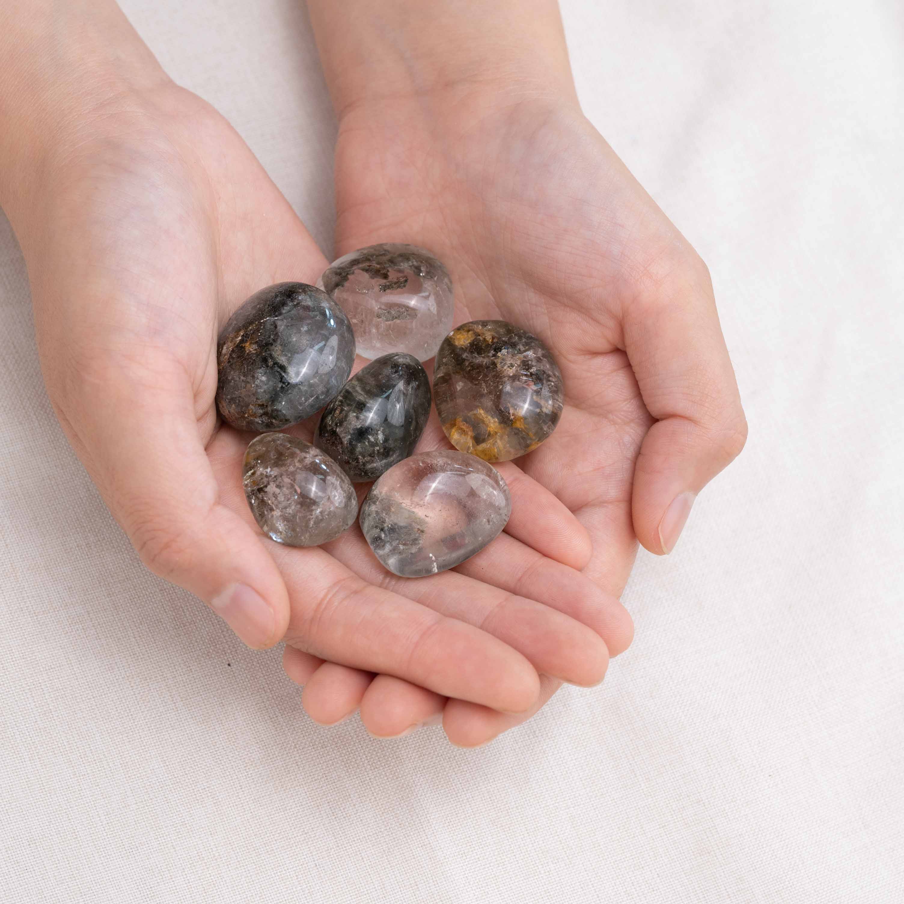 Laid-out Phantom Quartz tumbled stones for transformation