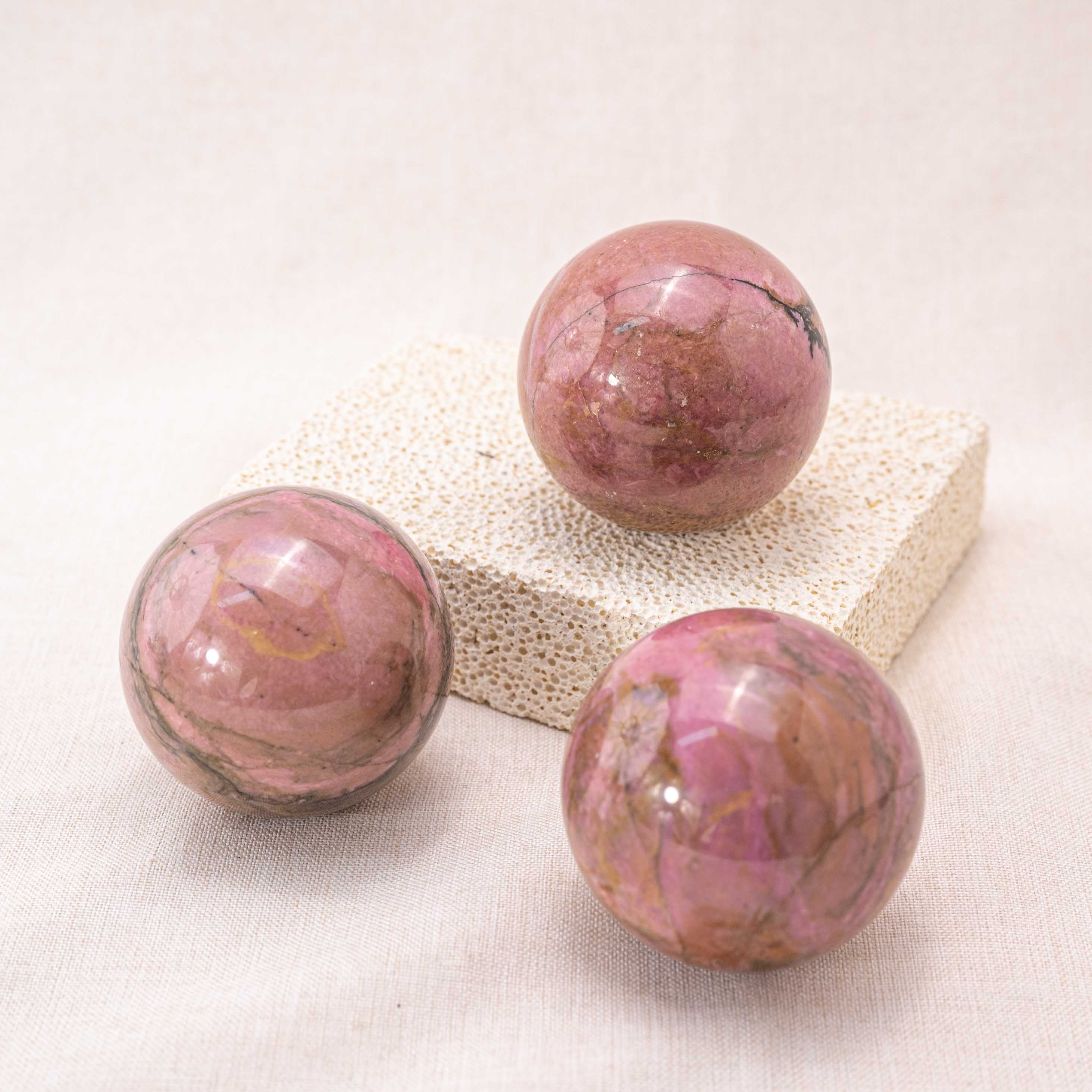 Pink Rhodonite Sphere with vibrant pink hues
