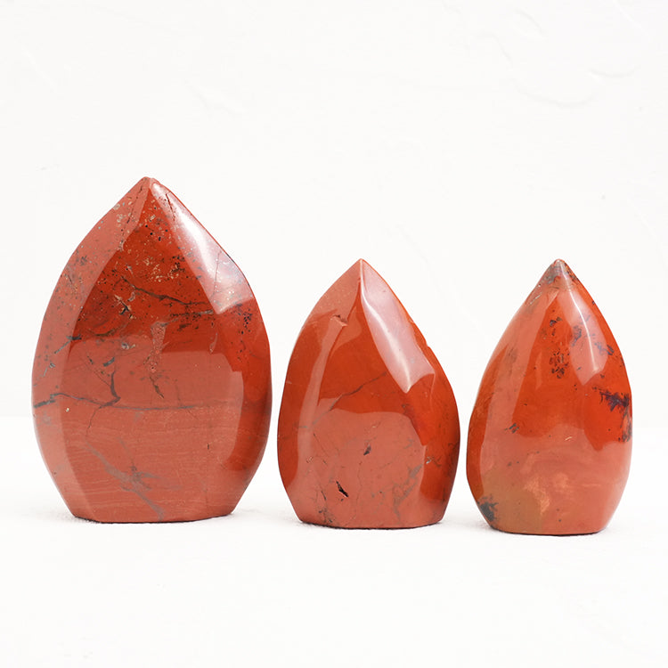 Polished Red Jasper Freeform Crystal on a white background highlighting its smooth surface
