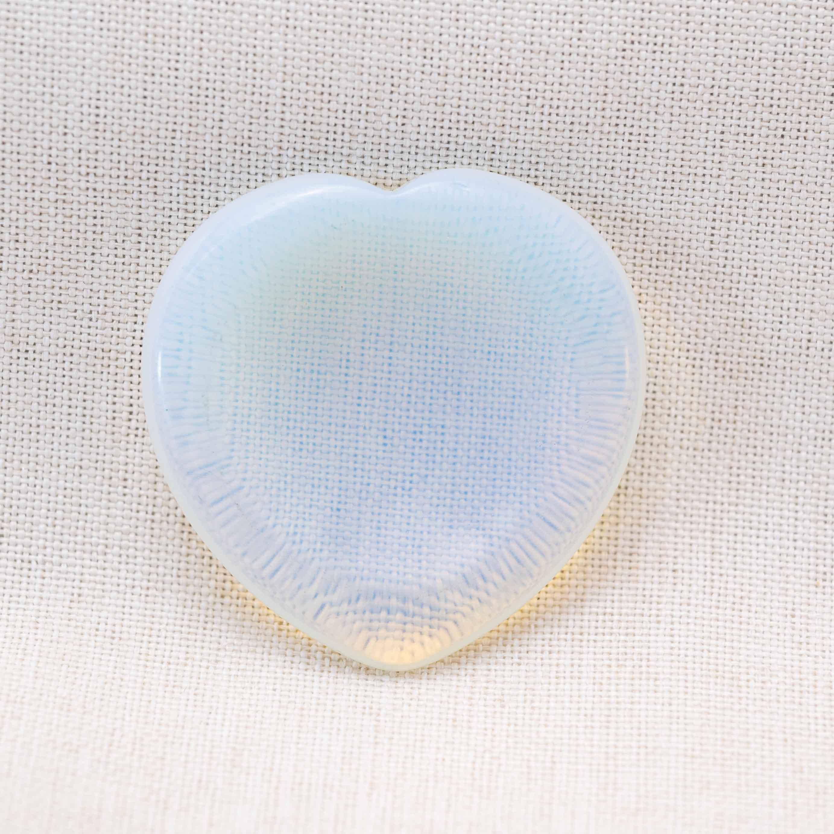 The Opalite Heart Worry Stone is known for its mesmerizing, iridescent glow