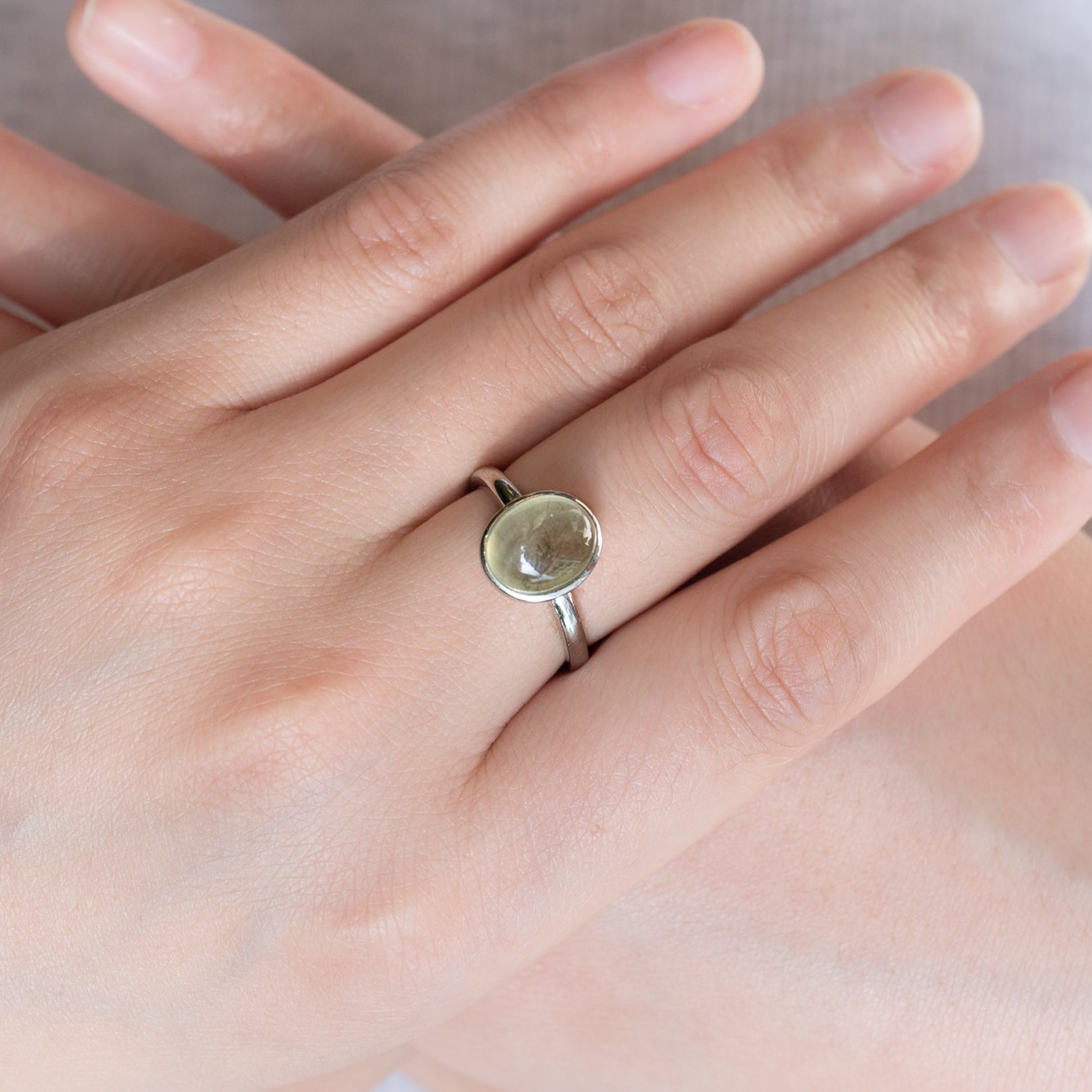 Elegant Prehnite Ring with alloy band and faceted green gemstone.