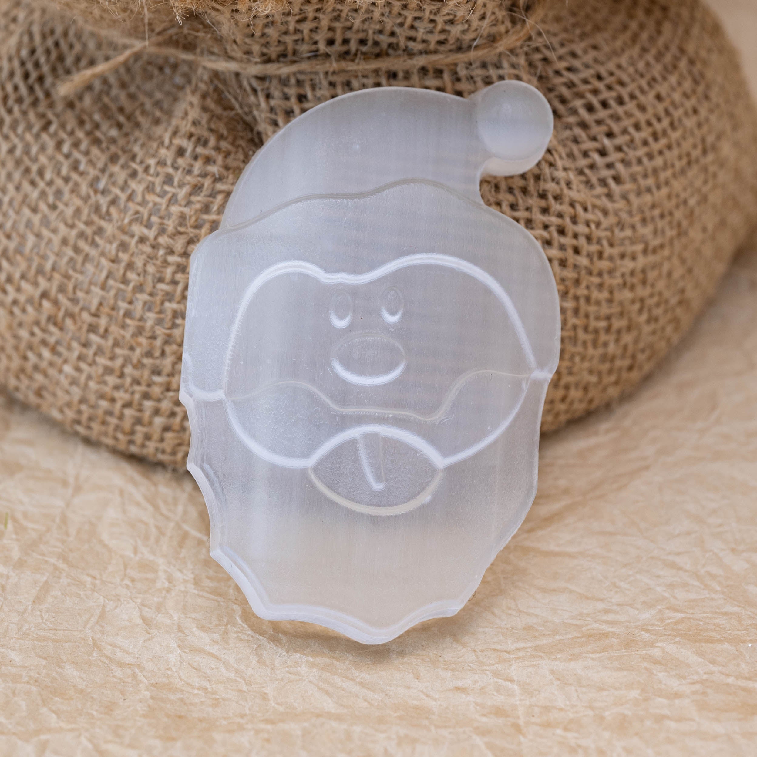 This Selenite Santa Claus carving promotes holiday cheer.