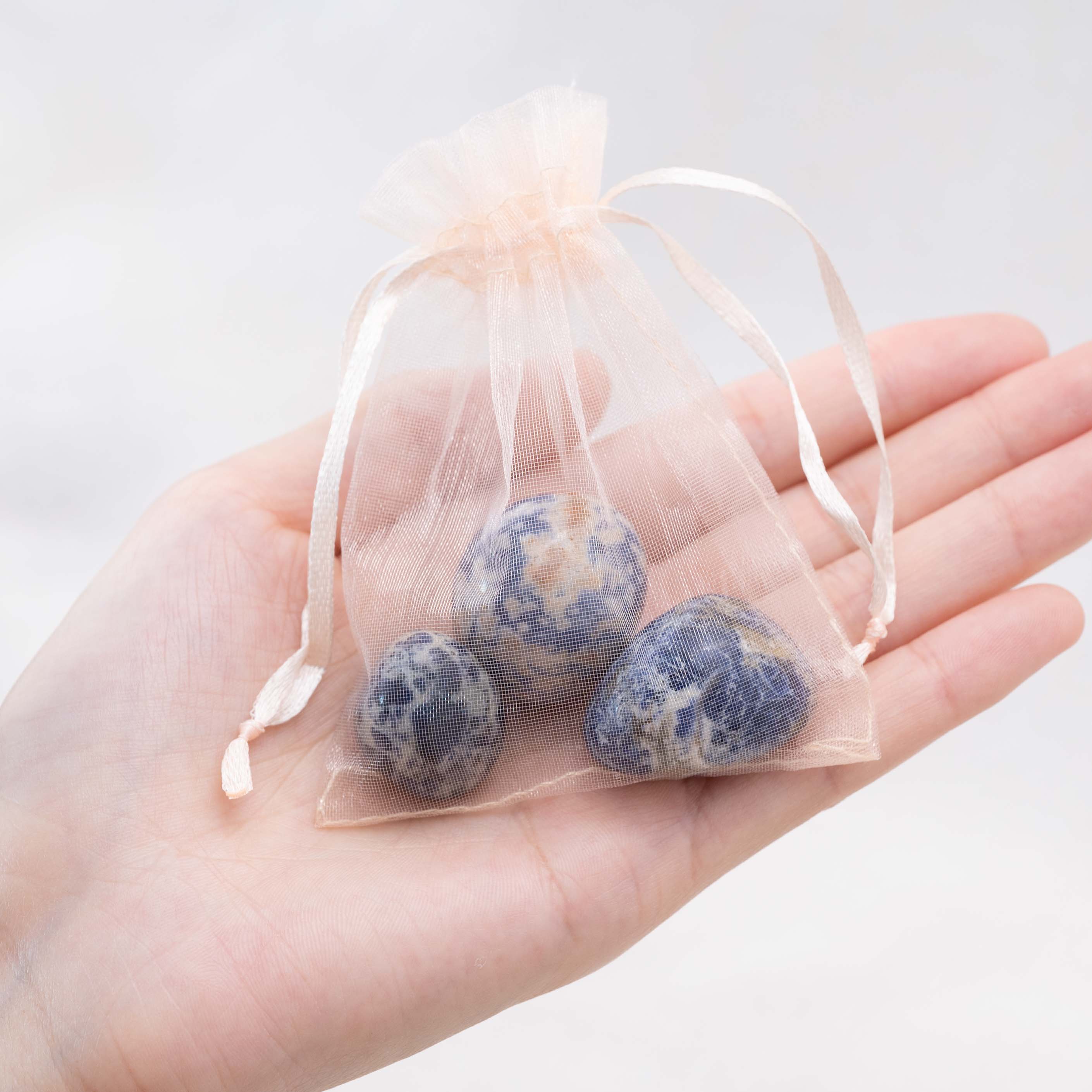 Detail shot of Sodalite tumbled stone's intricate patterns.