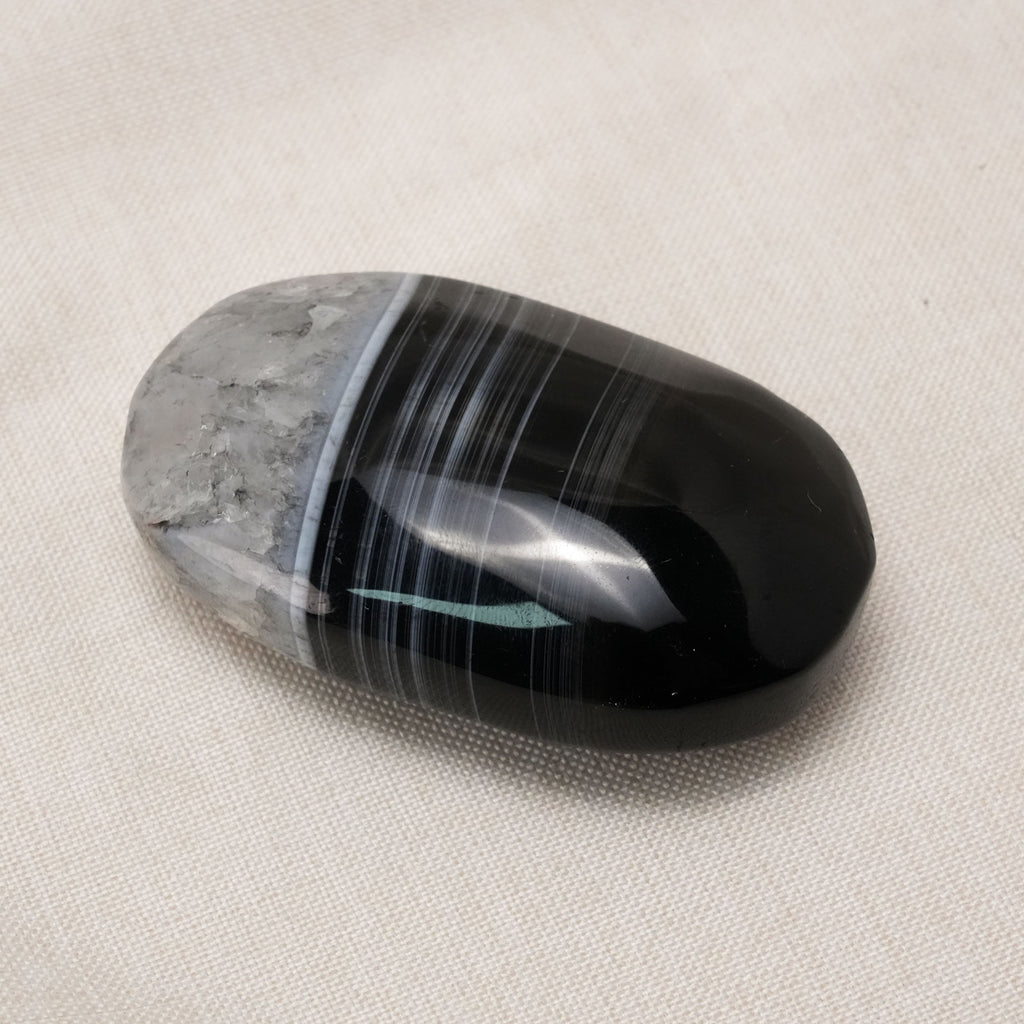 The Black Lace Agate Palm Stone is a powerful healing crystal known for its intricate patterns and grounding properties