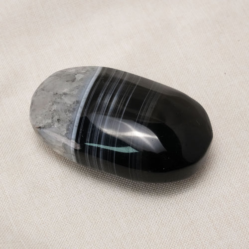 The Black Lace Agate Palm Stone is a powerful healing crystal known for its intricate patterns and grounding properties