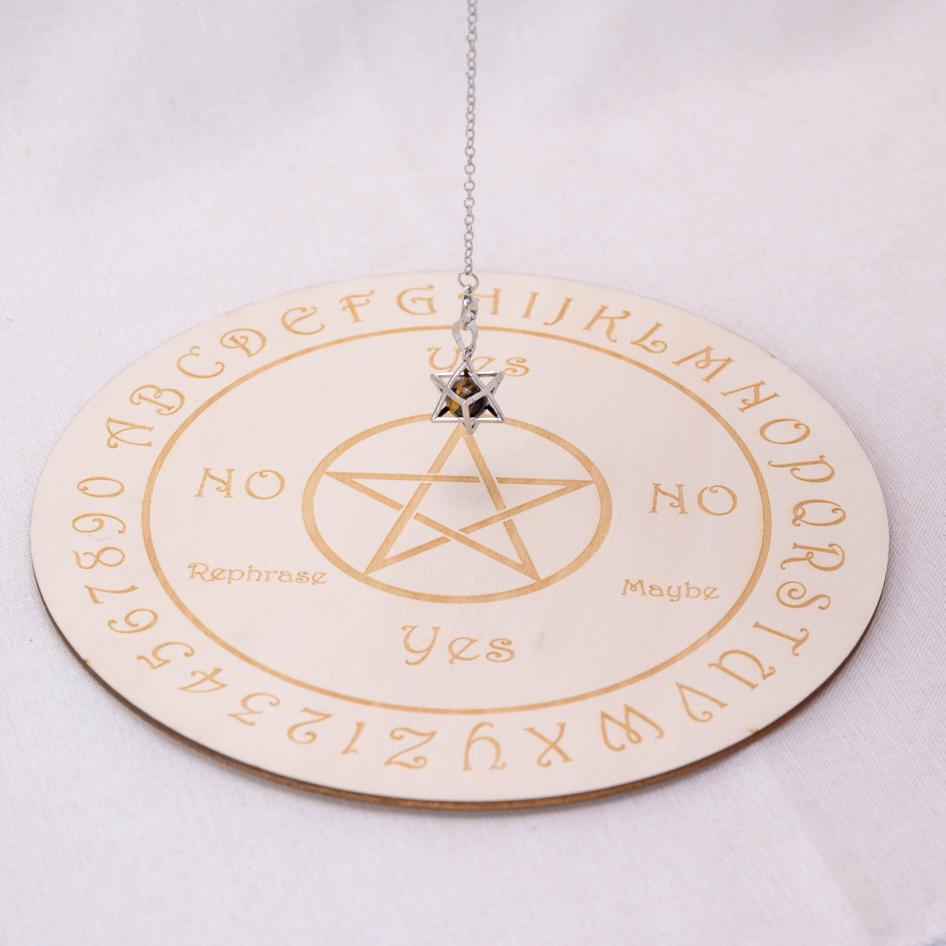 Detailed view of Tiger Eye Stone Merkaba-shaped pendulum