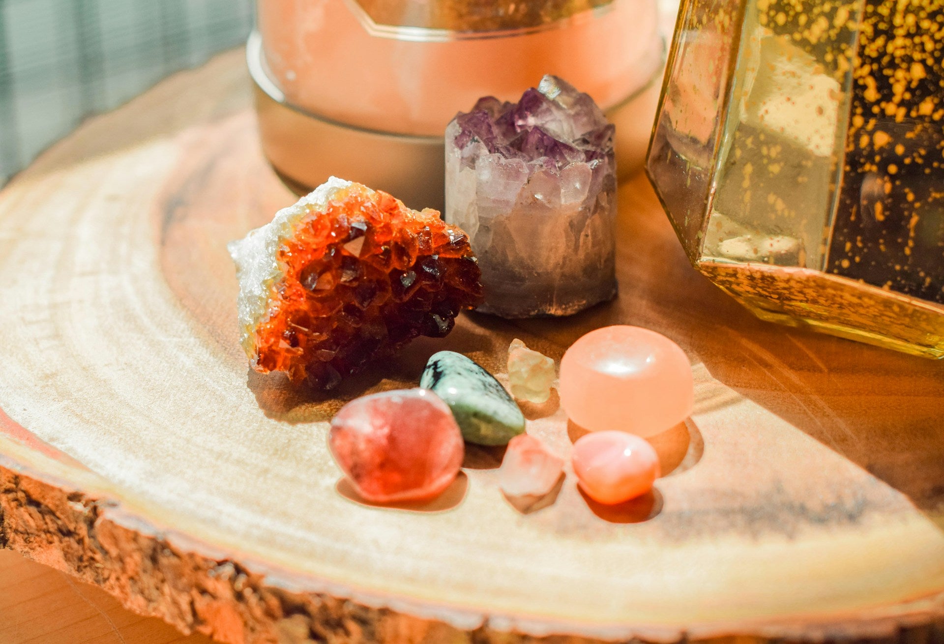 A vibrant collection of crystals such as citrine, amethyst, and other gemstones arranged on a wooden surface